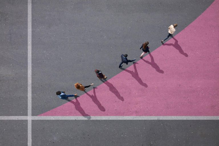 Businesspeople walking on painted up going graph, on asphalt